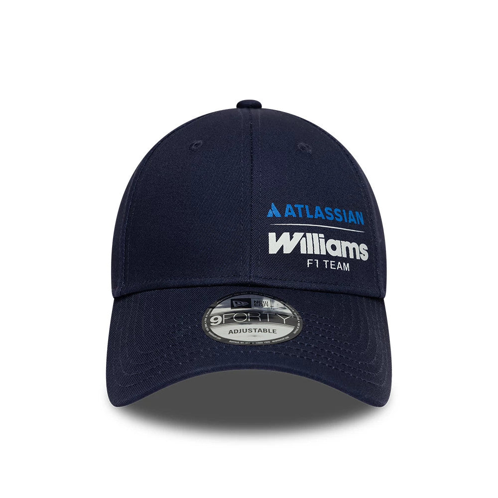 Williams Essential Navy New Era 9FORTY Adjustable Cap, front view showing the blue and white embroidered Williams F1 Team and Atlassian logos on the structured navy crown, with a curved visor and a 9FORTY size sticker centred on the visor.