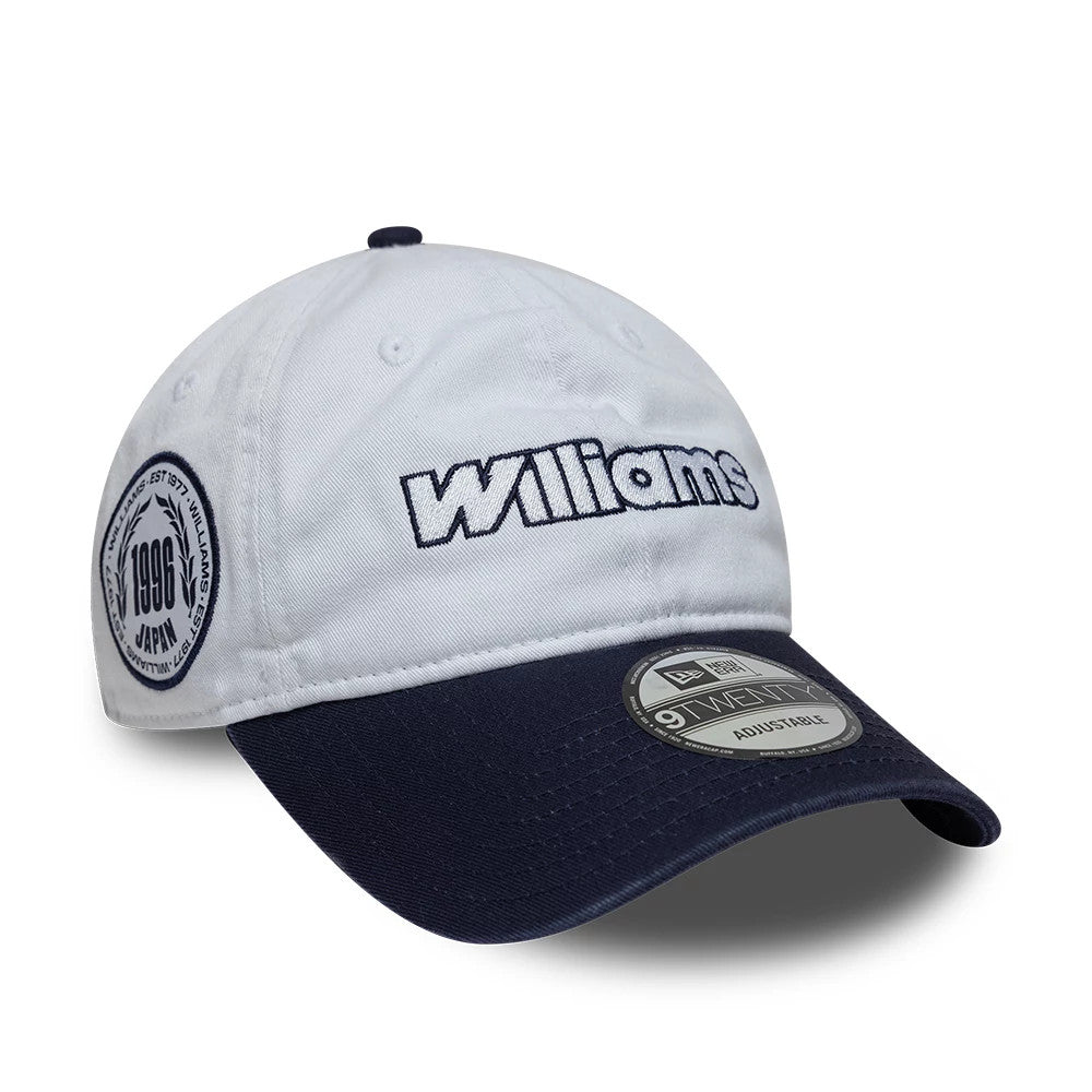 Williams Suzuka Race Special White New Era 9TWENTY Adjustable Cap, three-quarter view showing the embroidered Williams logo on the front panel, a navy visor with a 9TWENTY size sticker, and a circular badge on the side.