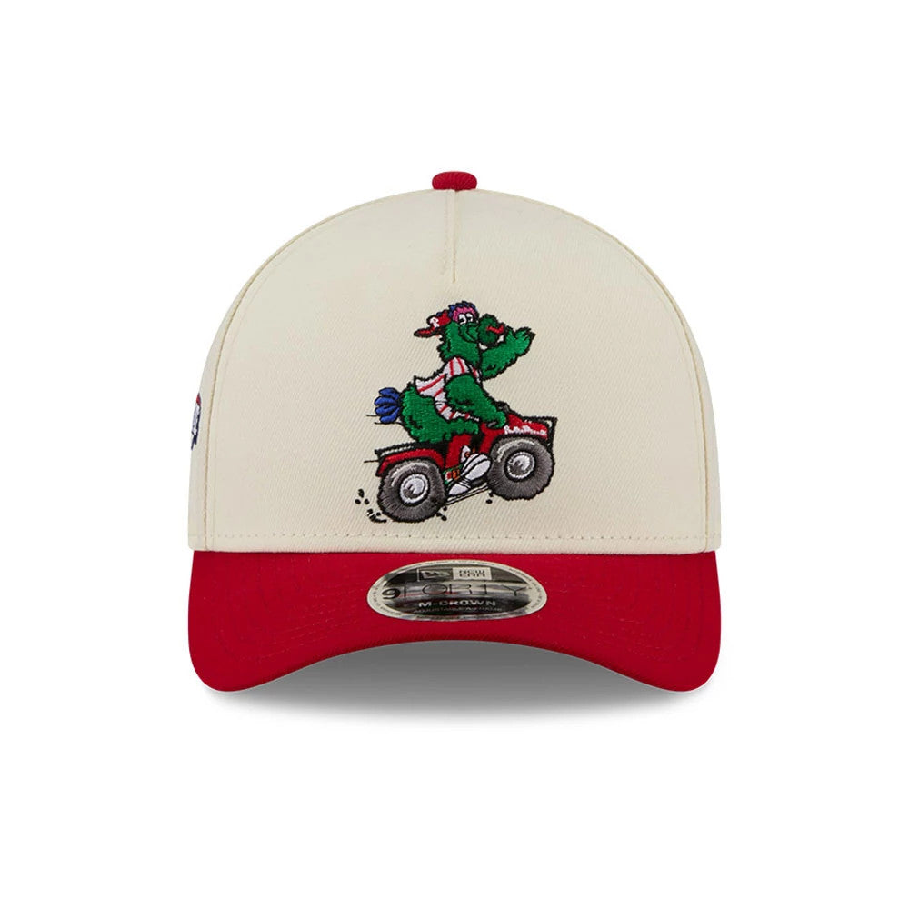 Phillies MLB All Star Game Cream New Era 9FORTY M-Crown A-Frame Adjustable Cap, front view showing a colourful embroidered green mascot riding a quad bike on the structured cream crown, with a contrasting red visor and a 9FORTY size sticker.