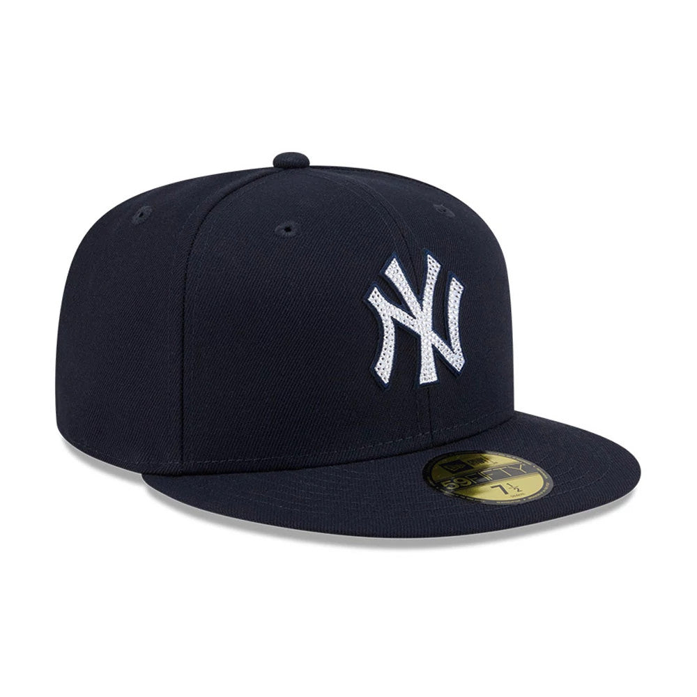 New York Yankees MLB Rhinestone Badge Navy New Era 59FIFTY Fitted Cap, three-quarter view showing the sparkling rhinestone-embellished Yankees logo in white embroidery on the front panel, with a structured navy crown.