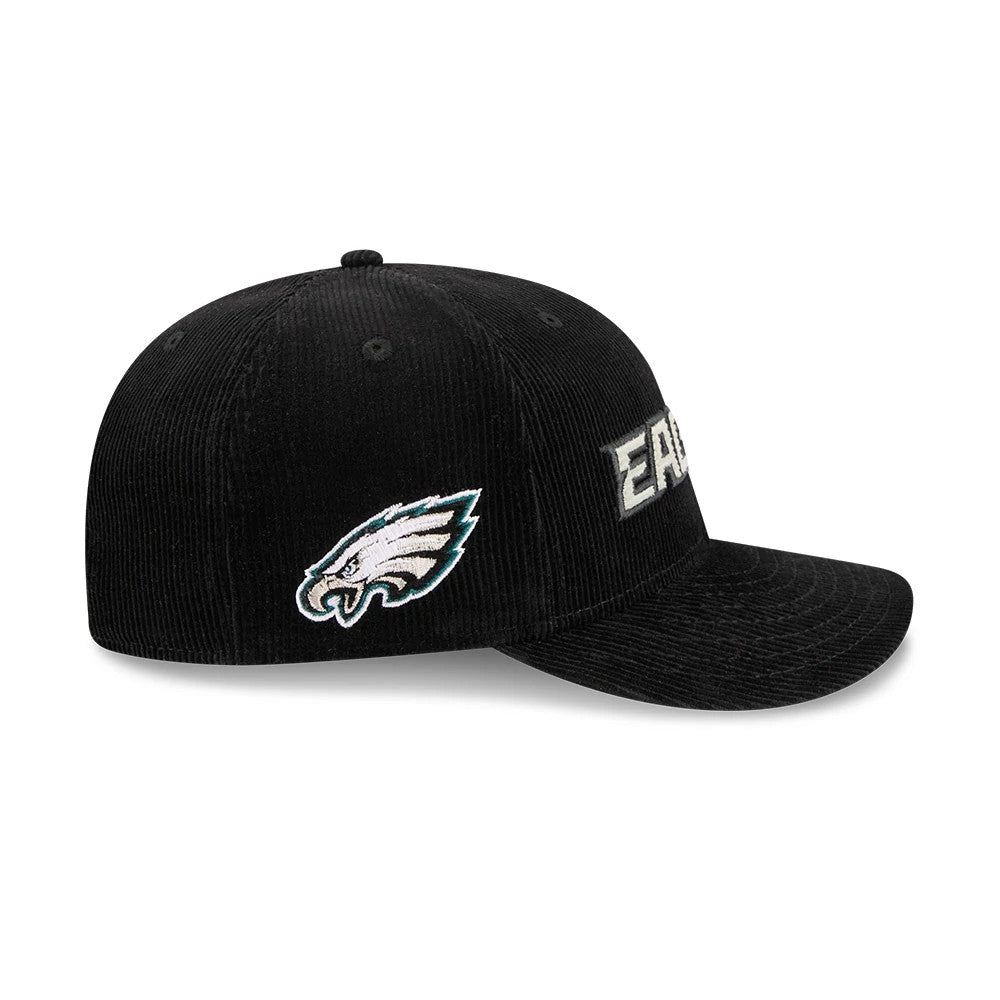 Eagles NFL 2 Tone Cord Black New Era 9FIFTY Snapback Adjustable Cap, three-quarter view showing the grey embroidered Eagles text on the front panel, the team logo on the left side, and the black corduroy flat visor and crown.