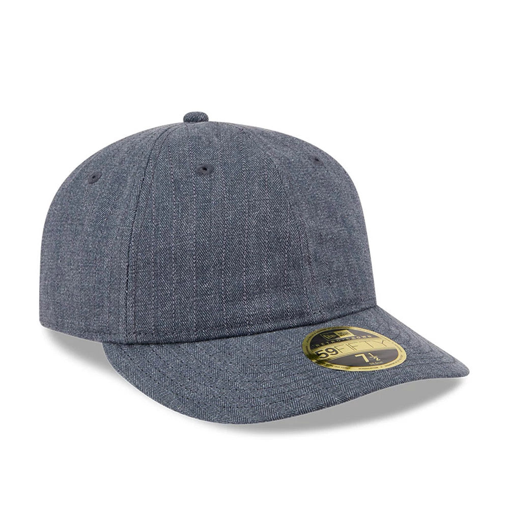 New Era Herringbone Navy Retro Crown 59FIFTY Fitted Cap, three-quarter view showing the textured herringbone pattern across the structured navy crown and flat visor, complete with a gold 59FIFTY size sticker on the visor’s top surface.