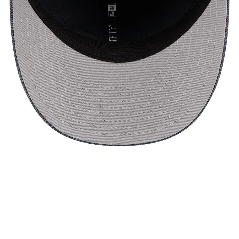 New Era Herringbone Navy Retro Crown 59FIFTY Fitted Cap, inside view showing the grey undervisor with detailed stitching, a black sweatband with a size label on one side, and branded taping along the interior seams.