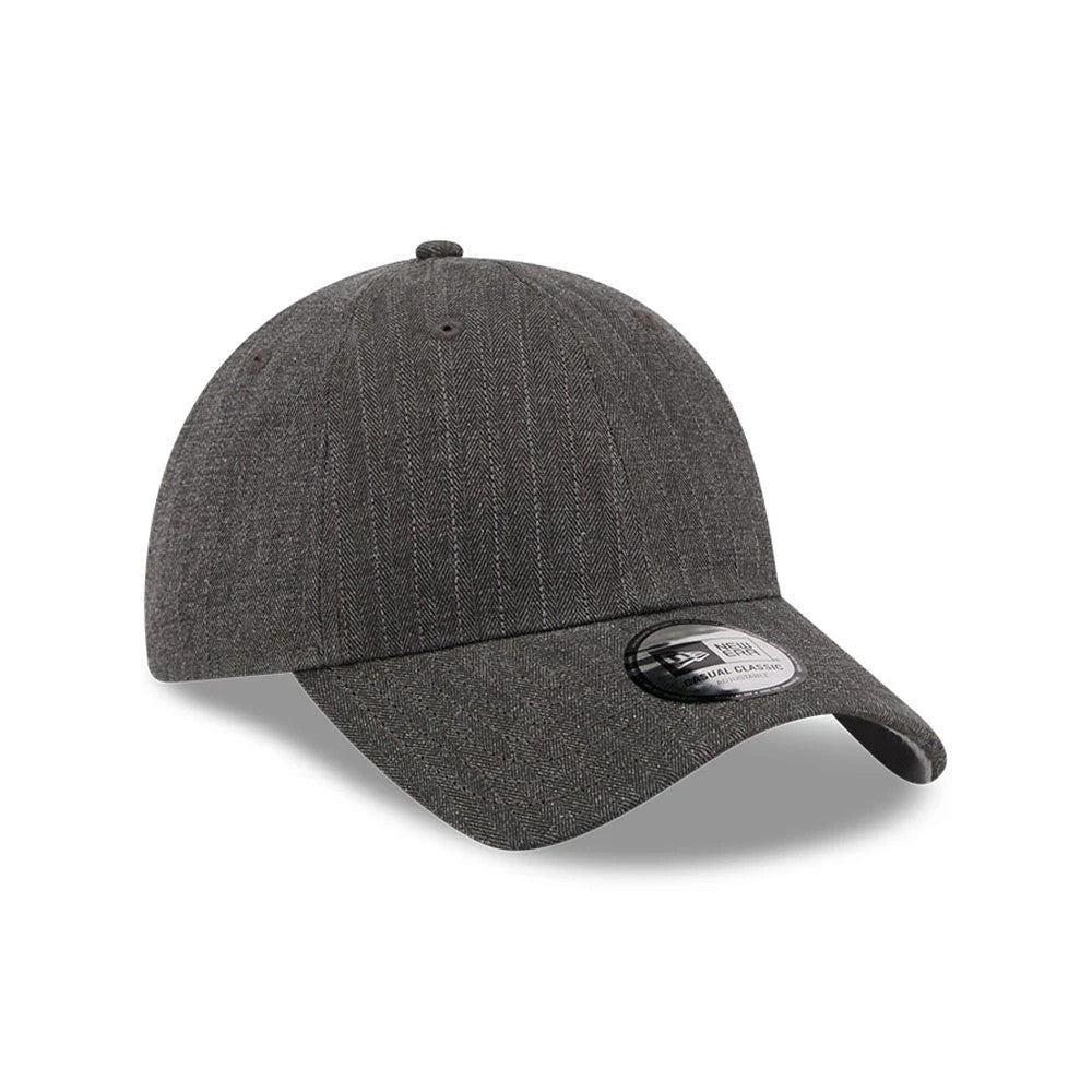 New Era Herringbone Pinstripe Charcoal Casual Classic Adjustable Cap, three-quarter view showing textured pinstripe on the unstructured charcoal crown, with a curved visor and a 9FORTY size sticker on the top panel.