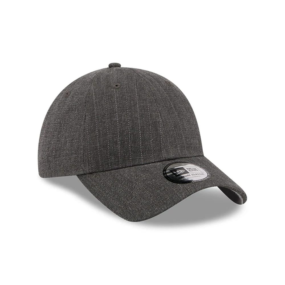 New Era Herringbone Pinstripe Charcoal Casual Classic Adjustable Cap, three-quarter view showing textured pinstripe on the unstructured charcoal crown, with a curved visor and a 9FORTY size sticker on the top panel.