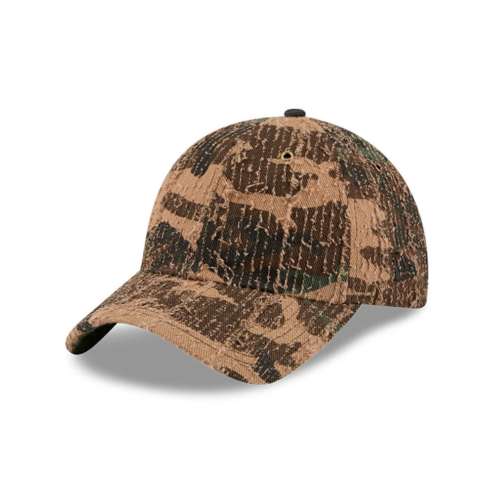 New Era Camo Casual Classic Adjustable Cap, three-quarter view showing the textured brown and green camo pattern across the unstructured crown and curved visor, with a black New Era flag logo embroidered on the left side.