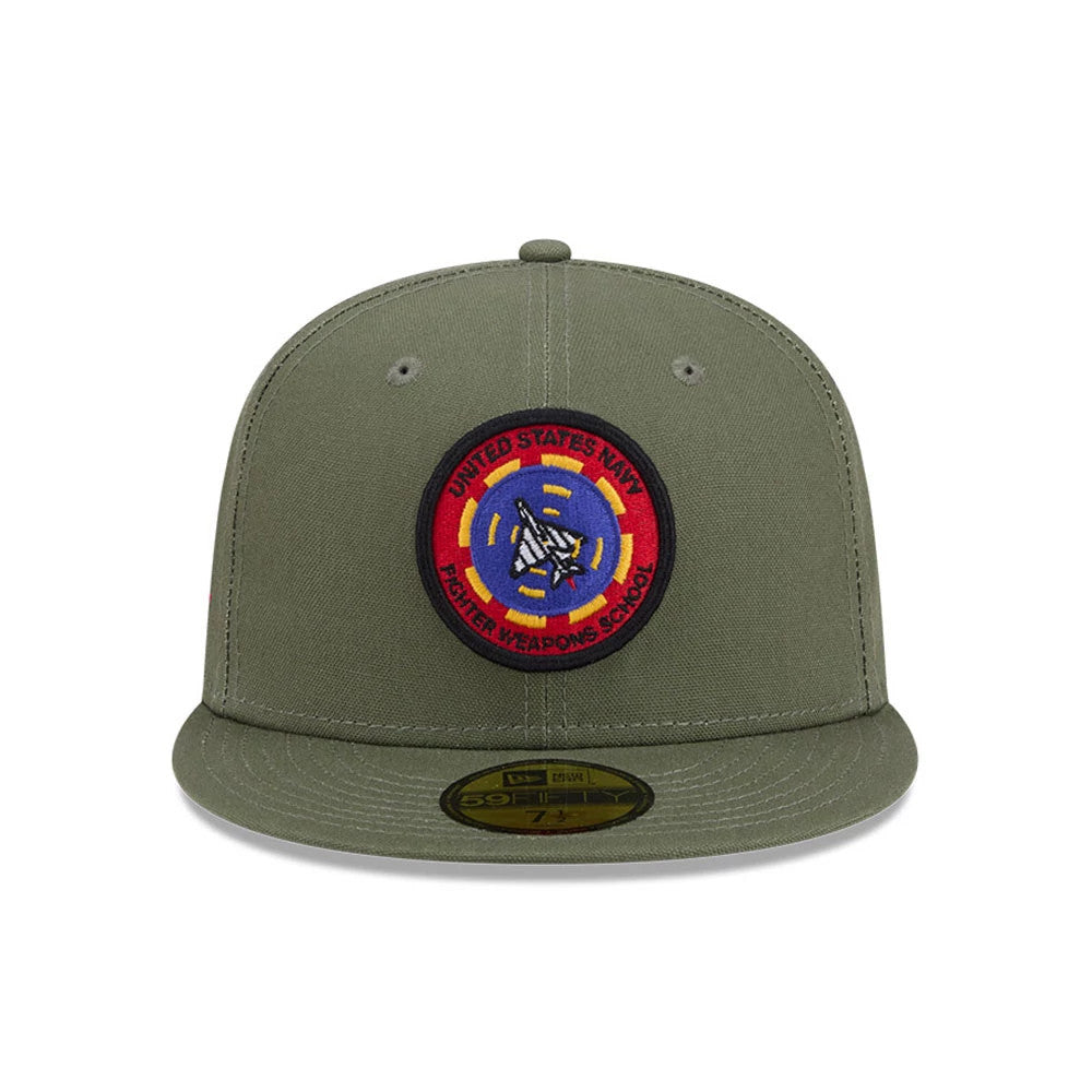 Top Gun Green New Era 59FIFTY Fitted Cap, front view showing a large round embroidered United States Navy Fighter Weapons School patch on the structured green crown, with a matching green flat visor and a gold 59FIFTY size sticker.