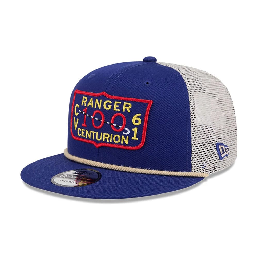 Top Gun Dark Blue New Era 9FIFTY Trucker Adjustable Cap, three-quarter view showing a raised embroidered badge with Ranger Centurion lettering on the structured blue front panel, a beige rope across the visor, and a 9FIFTY size sticker.