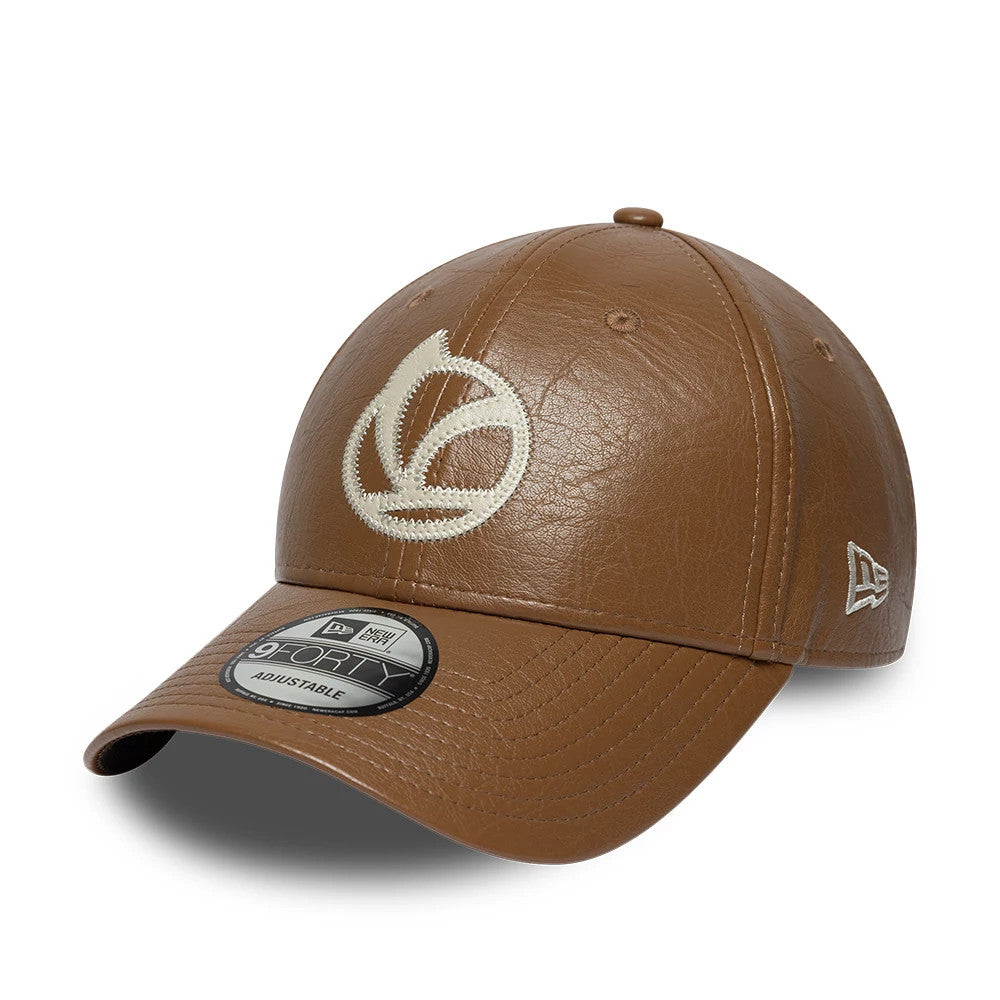 Vespa Crinkle PU Dark Brown New Era 9FORTY Adjustable Cap, three-quarter view showing a distinctive cream embroidered Vespa logo on the front panel, a pre-curved visor with a 9FORTY size sticker, and the New Era flag logo on the left side.