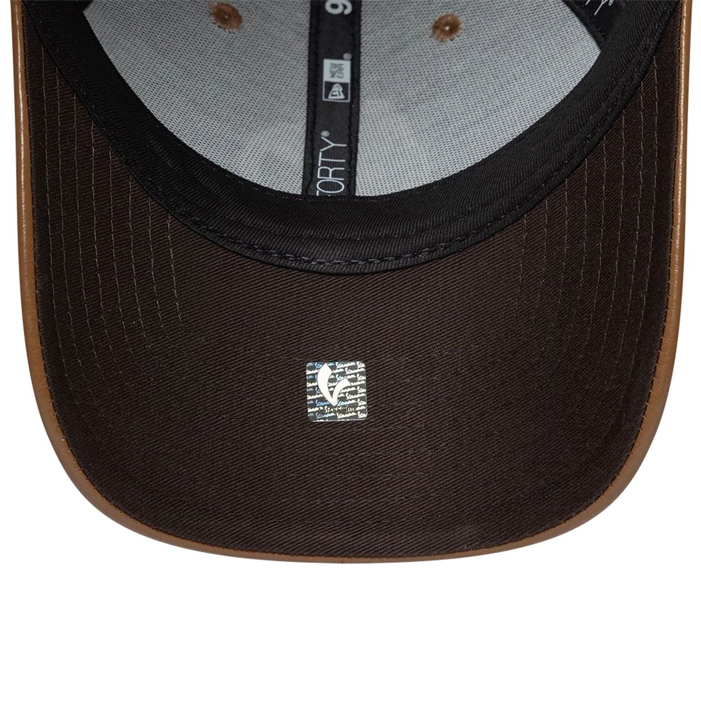 Vespa Crinkle PU Dark Brown New Era 9FORTY Adjustable Cap, inside view showing the black undervisor with a size sticker, grey taping with a 9FORTY logo, and a contrasting brown sweatband along the edge, highlighting detailed stitching.