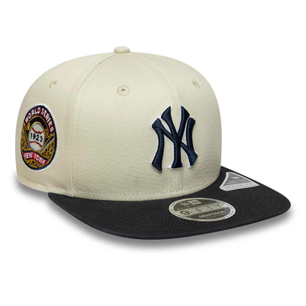 New York Yankees MLB World Series Patch Light Beige New Era 9FIFTY Snapback Adjustable Cap, front view showing a raised navy NY logo on the front panel, a contrasting black visor with a 9FIFTY size sticker.