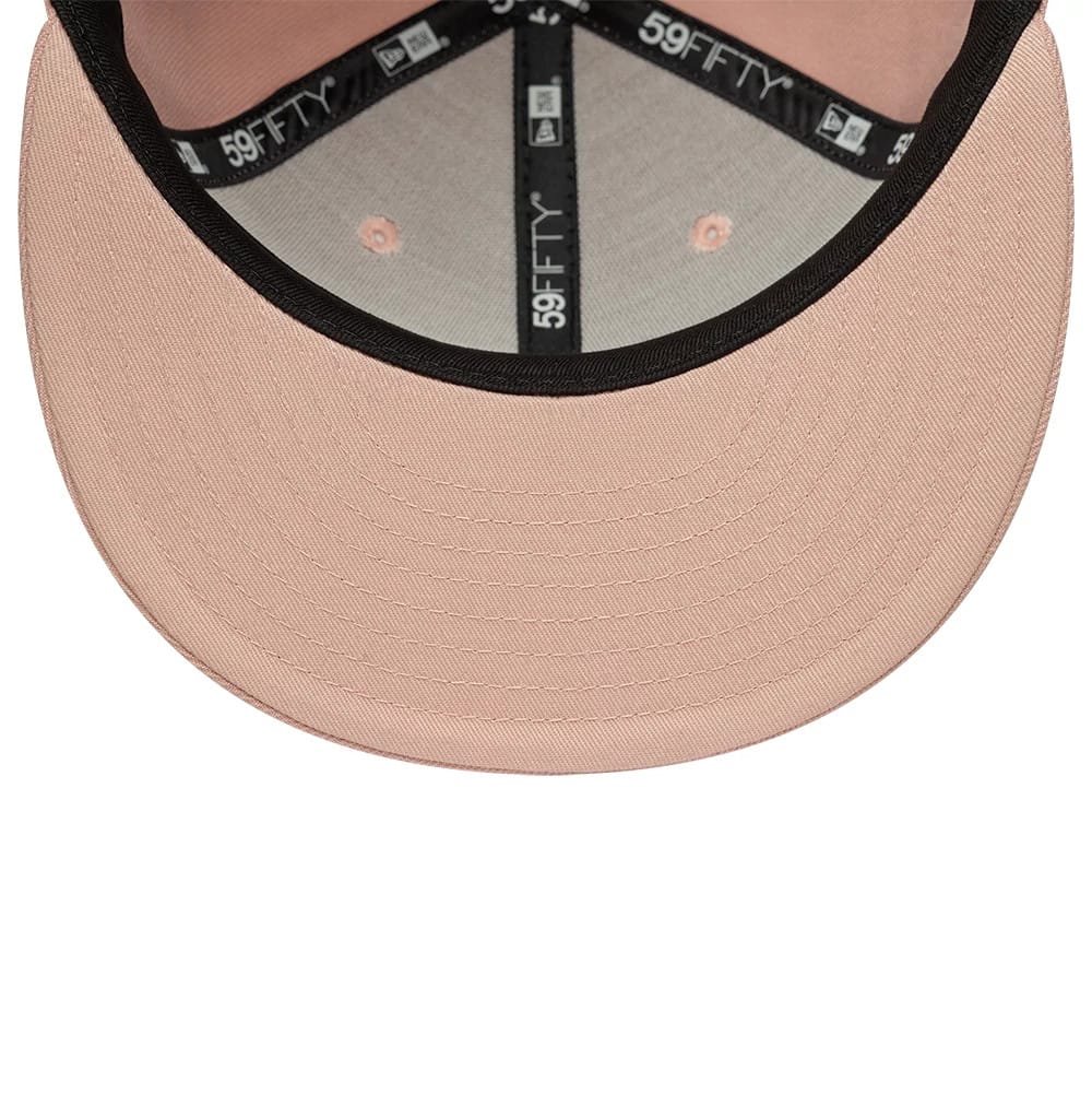 New York Yankees MLB League Essential Pastel Pink New Era 59FIFTY Fitted Cap, inside view showing the grey undervisor, black 59FIFTY taping along the seams, and pastel pink sweatband, with matching stitching and eyelets enhancing the interior design.