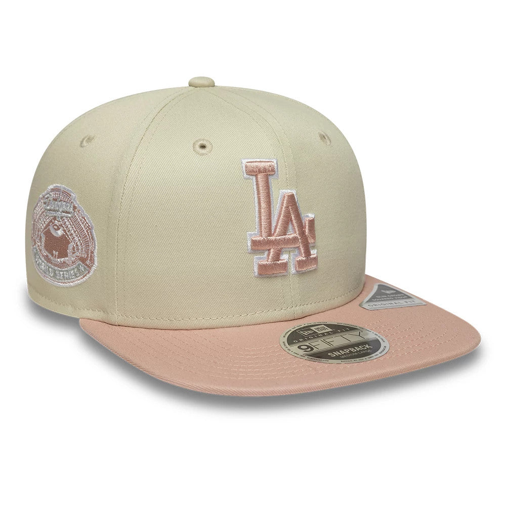 LA Dodgers MLB World Series Patch Light Beige New Era 9FIFTY Snapback Adjustable Cap, front view showing the light pink LA logo embroidered on the front panel, a matching visor with a 9FIFTY size sticker, and a side World Series patch.