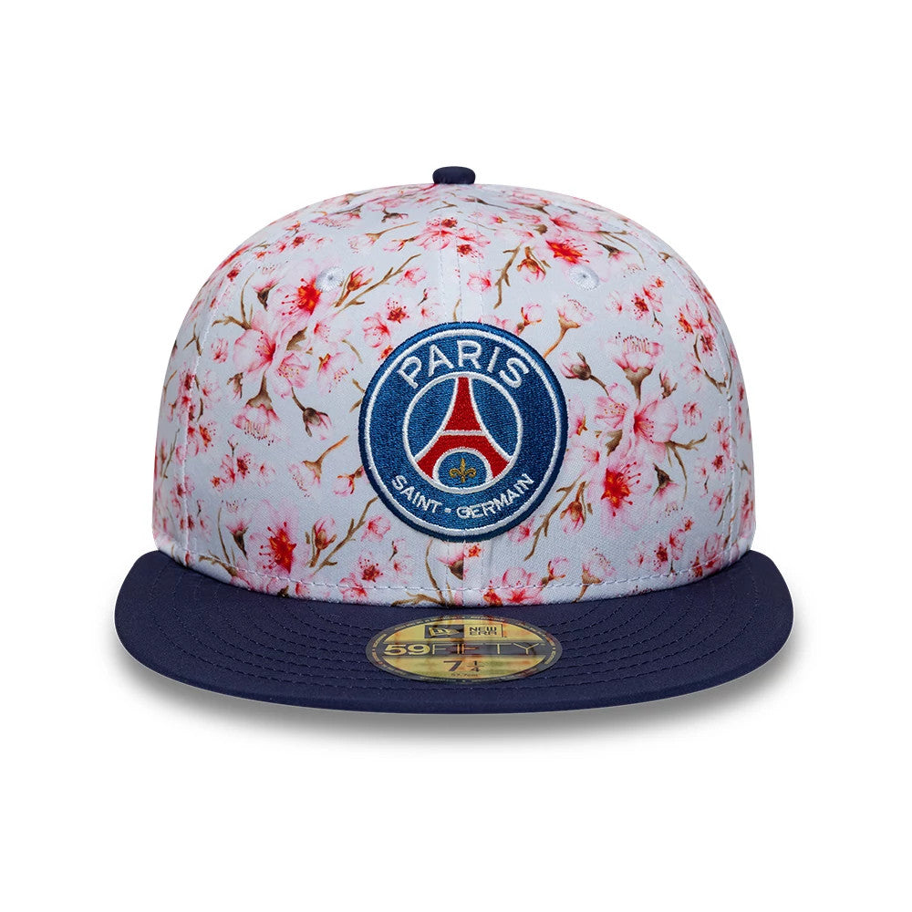 Paris Saint-Germain Cherry Blossom Navy New Era 59FIFTY Fitted Cap, front view showing the blue and red Paris Saint-Germain embroidered logo on the floral patterned crown, with a navy flat visor and a gold 59FIFTY size sticker.
