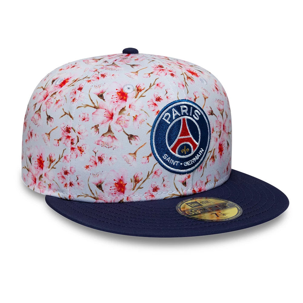 Paris Saint-Germain Cherry Blossom Navy New Era 59FIFTY Fitted Cap, front view showing a raised embroidered PSG logo on the front panel, with a cherry blossom floral pattern on the crown and a navy flat visor with a gold 59FIFTY size sticker.