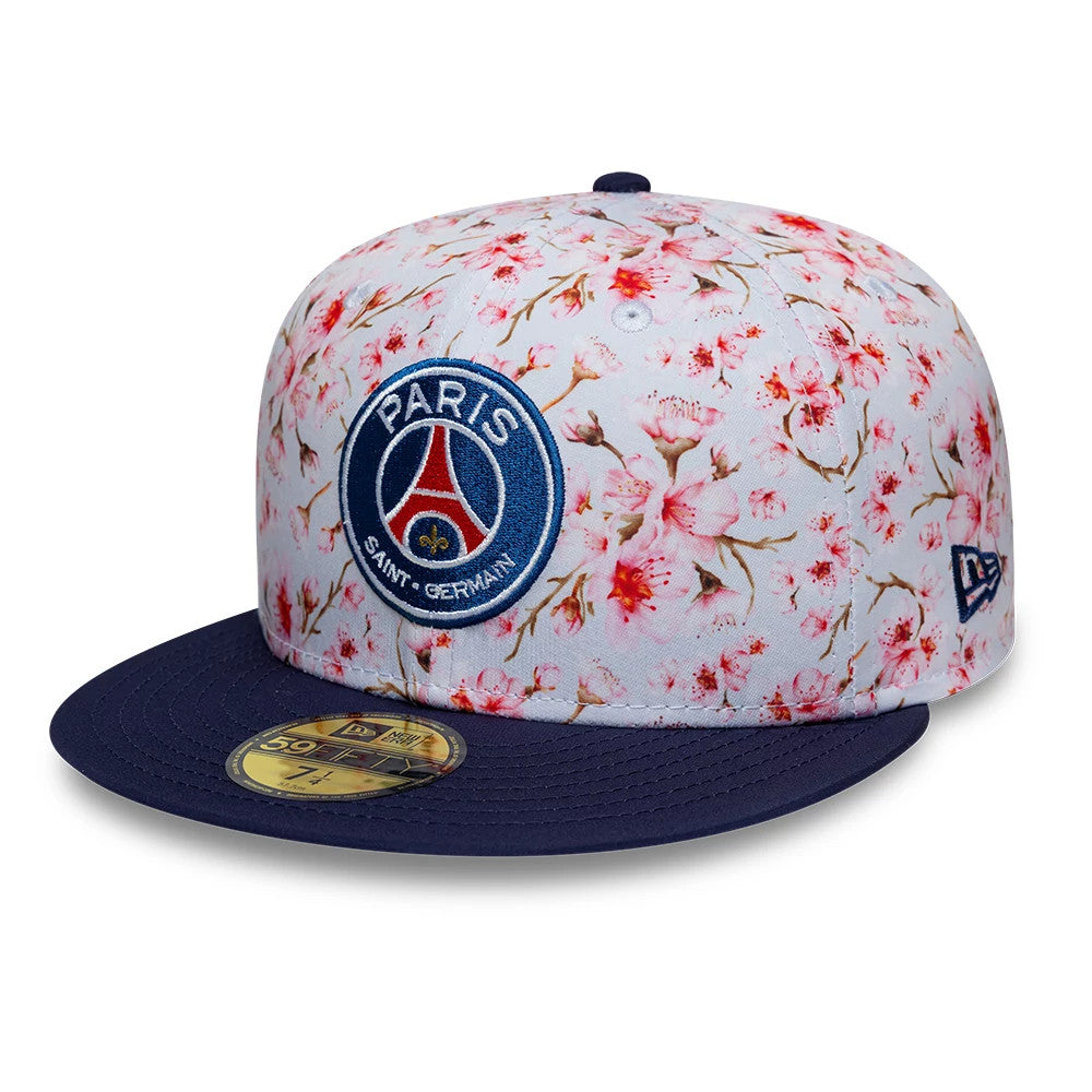 Paris Saint-Germain Cherry Blossom Navy New Era 59FIFTY Fitted Cap, front view showing the team crest in blue and red raised embroidery on the front panel, with an all-over cherry blossom design, navy flat visor and gold 59FIFTY size sticker.