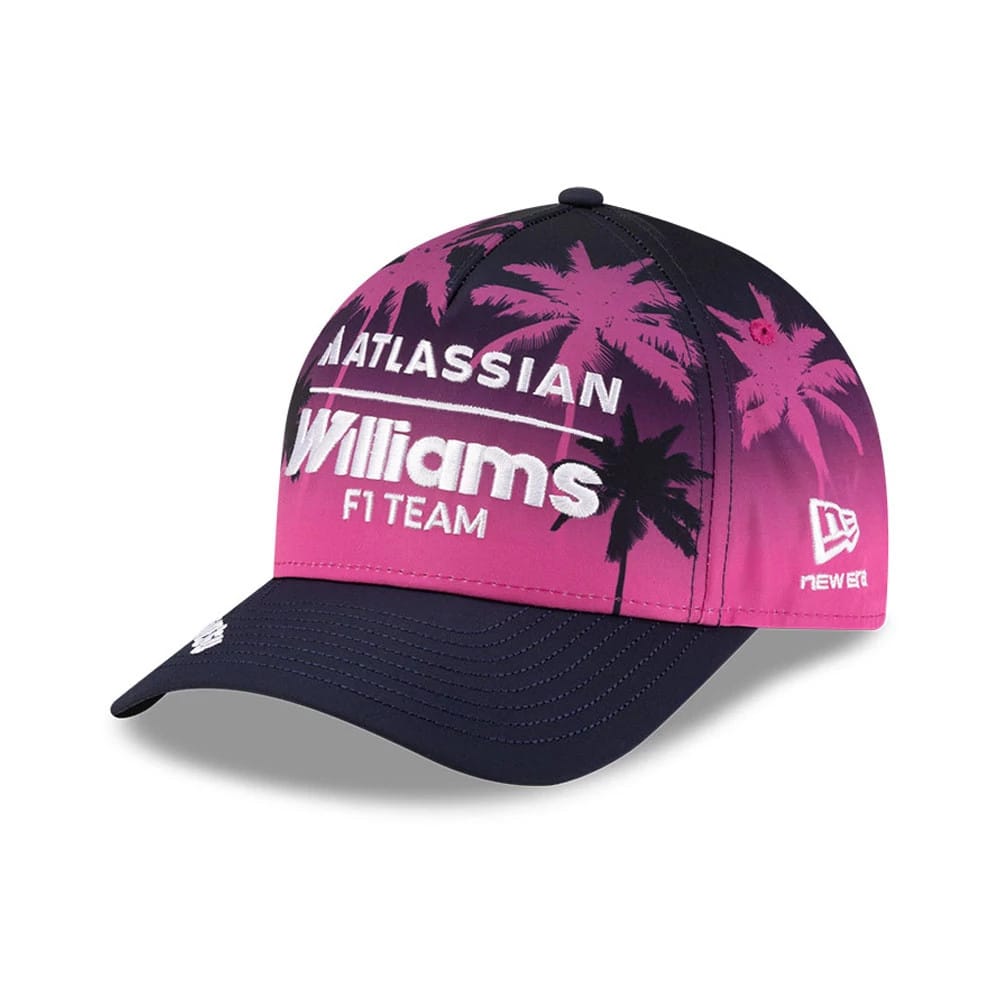 Williams Miami Navy New Era 9FORTY M-Crown A-Frame Adjustable Cap, three-quarter view showing the embroidered white Williams F1 Team logo on a pink gradient front with palm tree graphics, navy curved visor, and New Era flag logo on the left side.