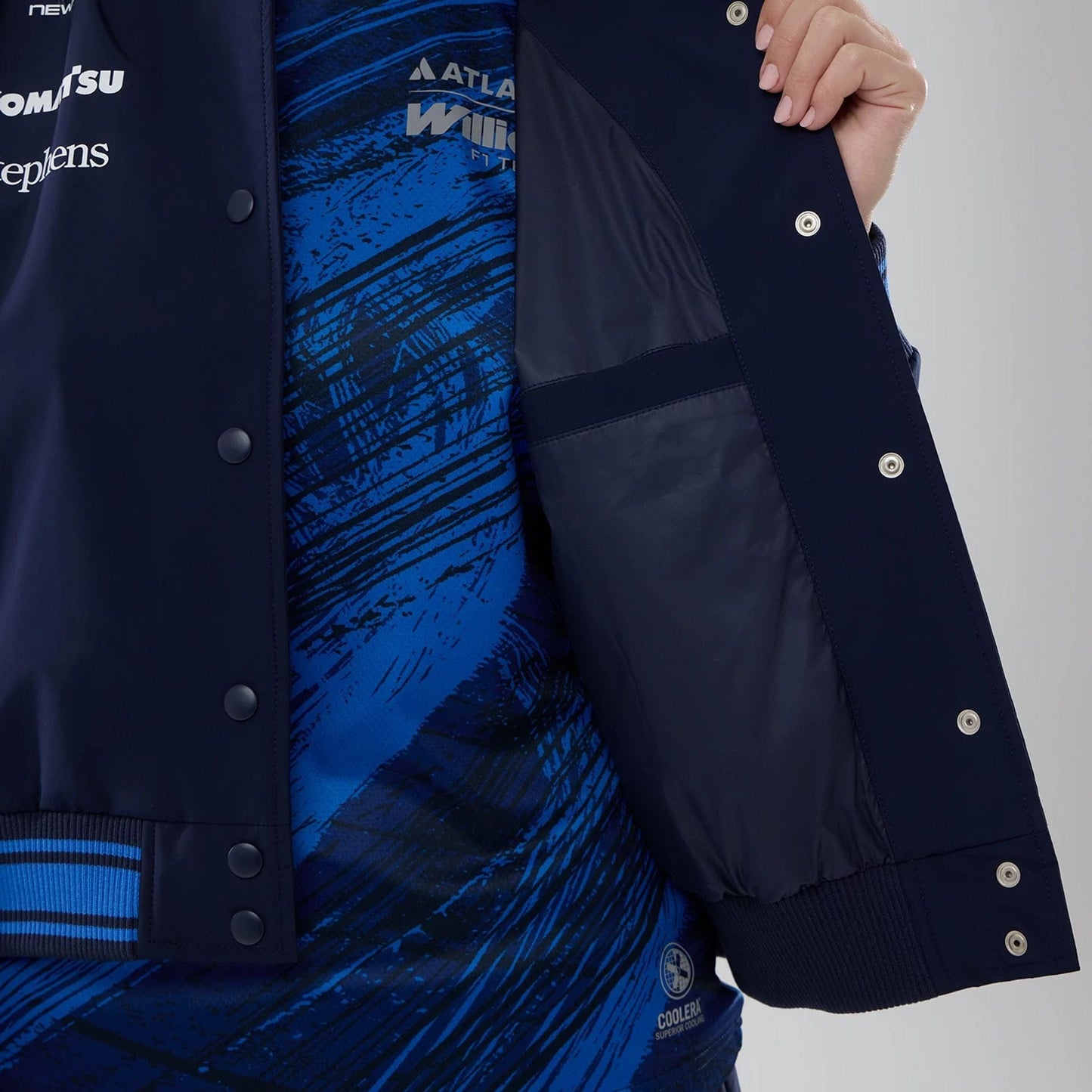 The model is wearing this Womens Atlassian Williams F1 Team Varsity Jacket in navy. 7