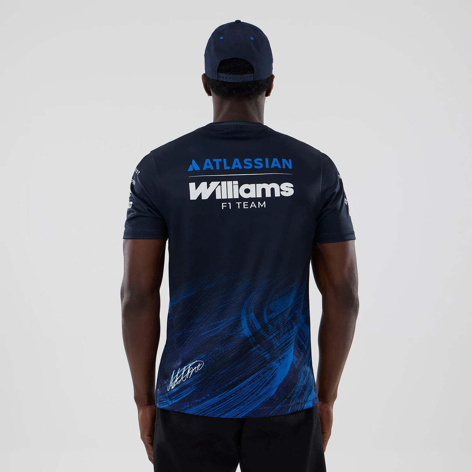 The model is wearing this Alex Albon Atlassian Williams F1 Team Tech T-shirt in navy. 2