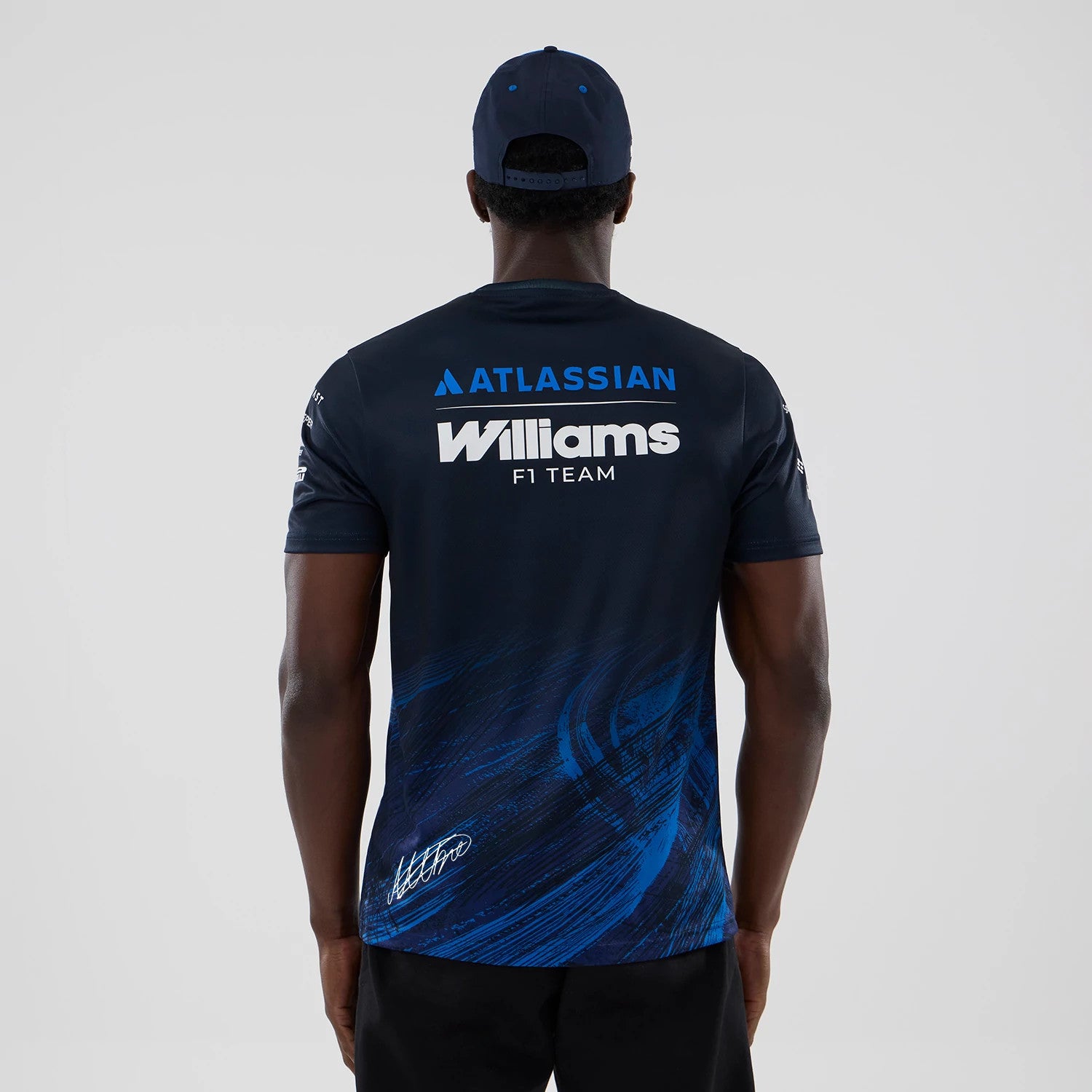 The model is wearing this Alex Albon Atlassian Williams F1 Team Tech T-shirt in navy. 2