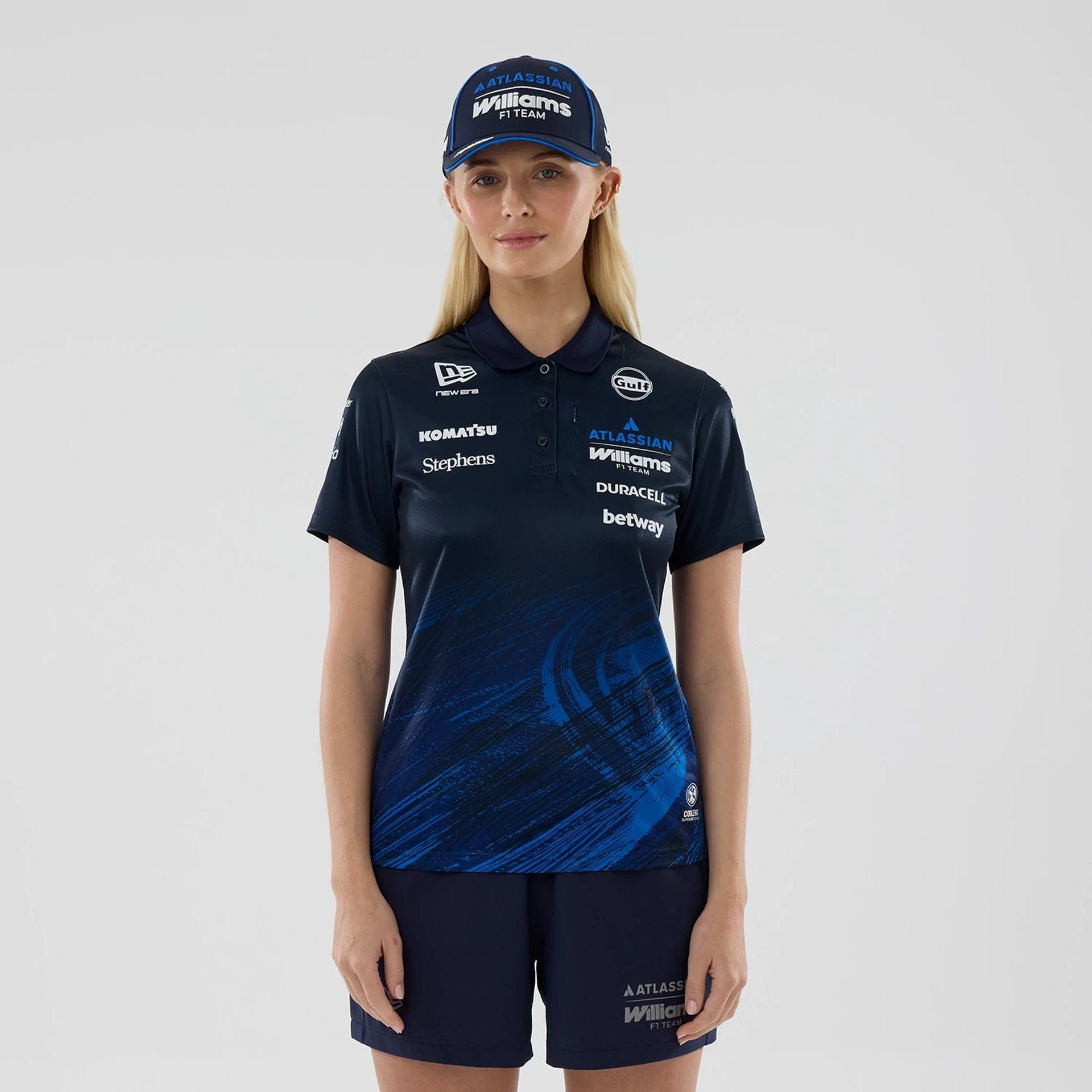 The model is wearing this Womens Atlassian Williams F1 Team Tech Polo T-shirt in navy. 1