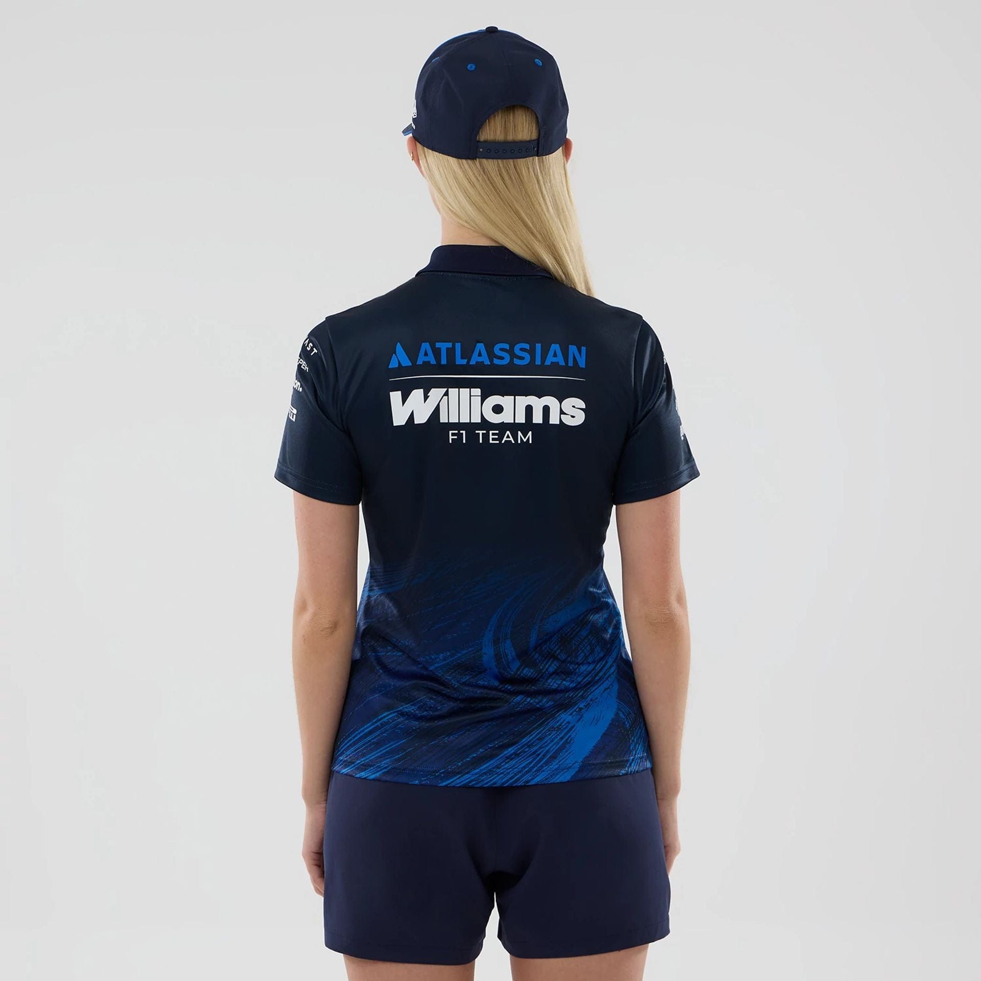 The model is wearing this Womens Atlassian Williams F1 Team Tech Polo T-shirt in navy. 2
