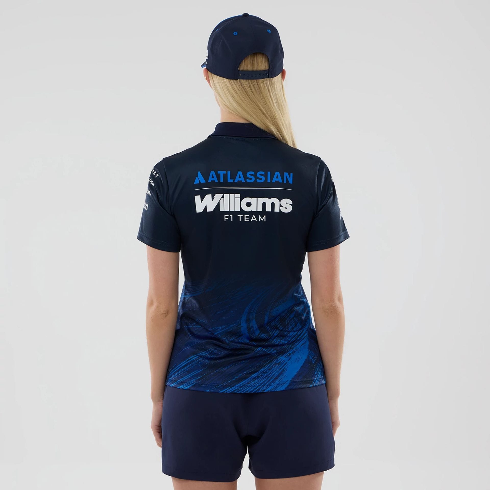 The model is wearing this Womens Atlassian Williams F1 Team Tech Polo T-shirt in navy. 2