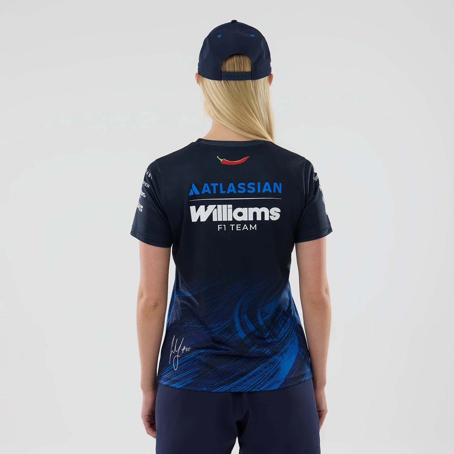 New Era Williams Womens Carlos Sainz Navy Tech T-shirt, back view showing white Williams F1 Team lettering with a curved red graphic and Atlassian logo above, blue abstract design on the lower half and a signature on the right side.