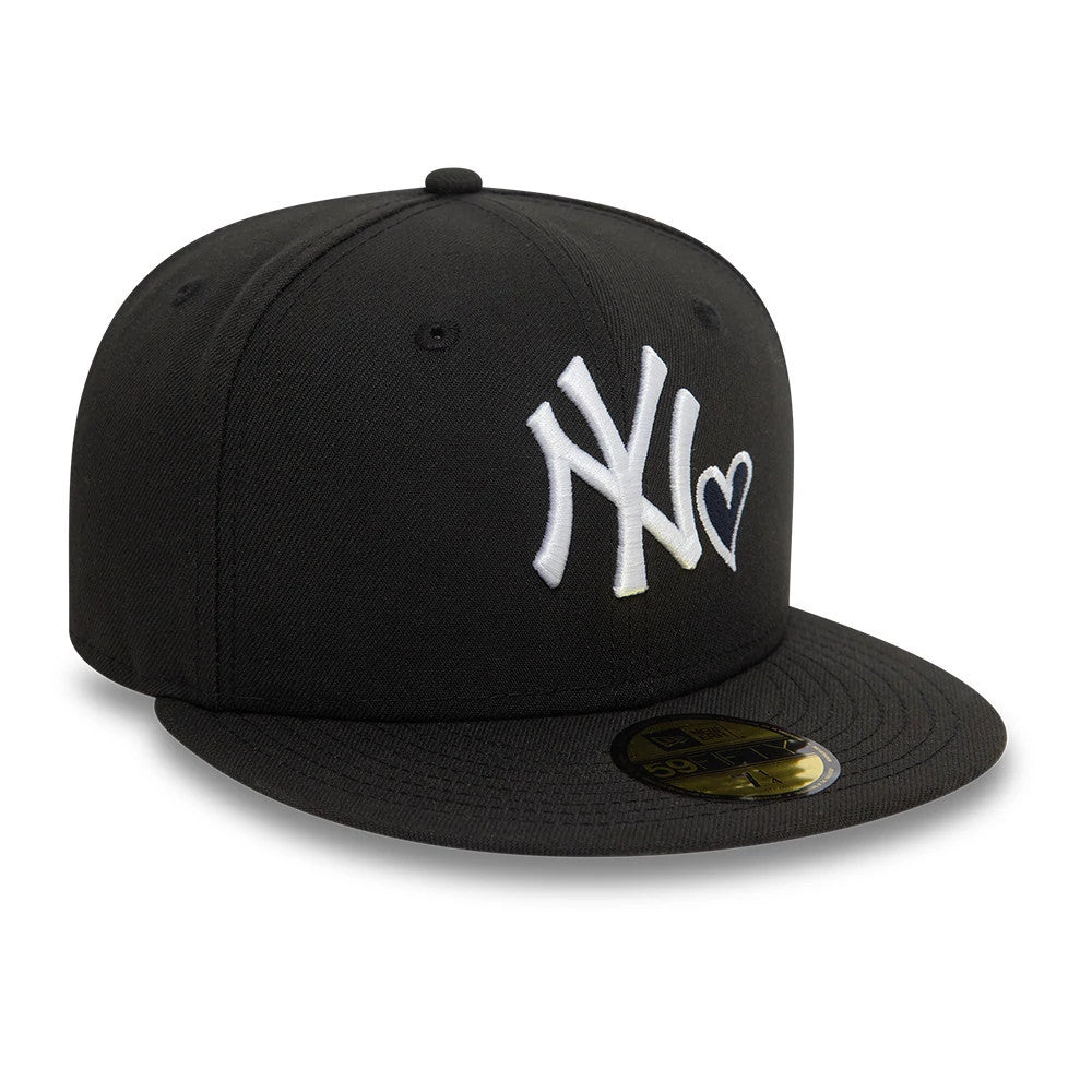 New York Yankees MLB Heart Icon Black New Era 59FIFTY Fitted Cap, three-quarter view showing a white embroidered NY logo with a heart icon on the front panel, a flat black visor, and a gold 59FIFTY size sticker.