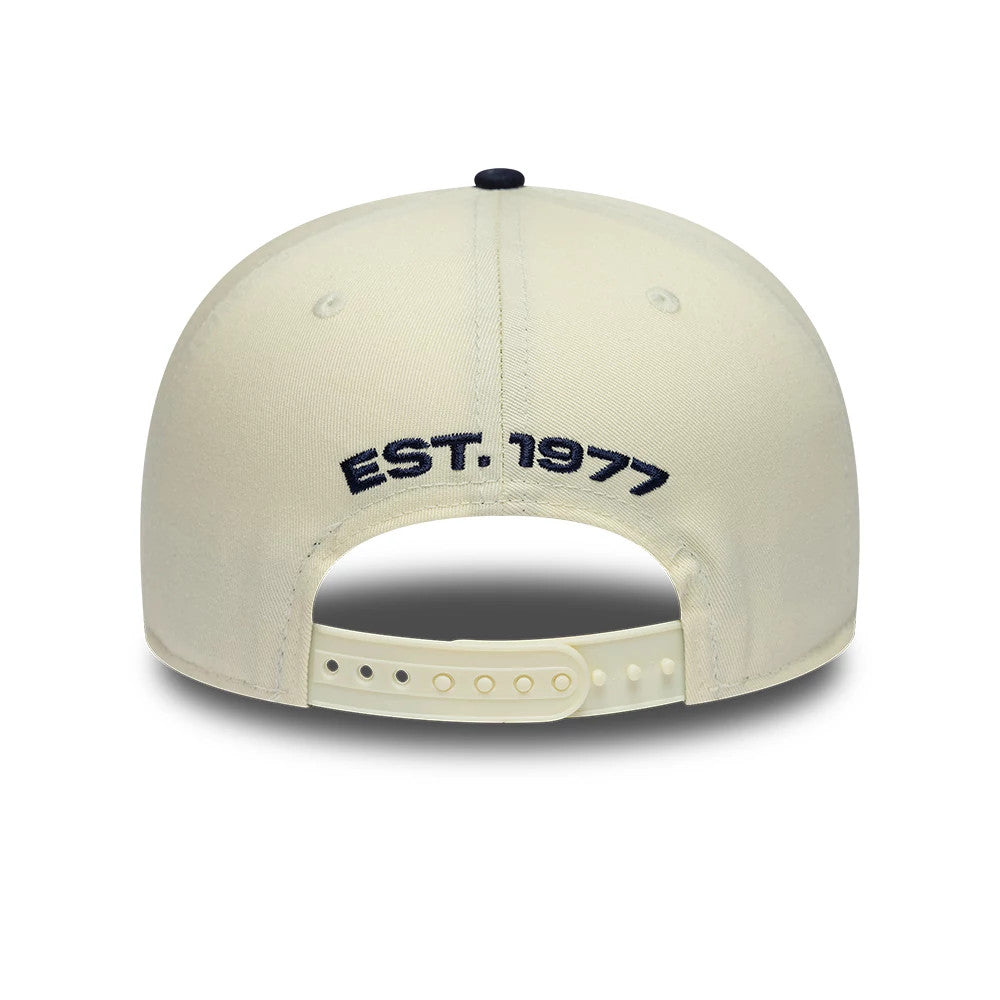 Williams New Wave Cream New Era Retro Crown 9FIFTY Adjustable Cap, rear view showing EST. 1977 in navy embroidery below the top button, with a cream snap closure and matching crown complemented by eyelets.
