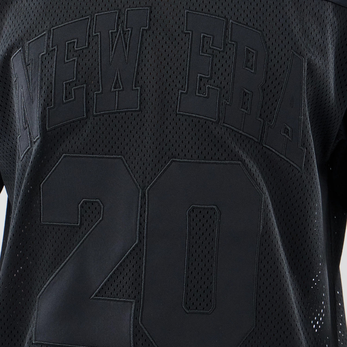 The model is wearing this New Era Mesh Oversized T-Shirt in black. 4