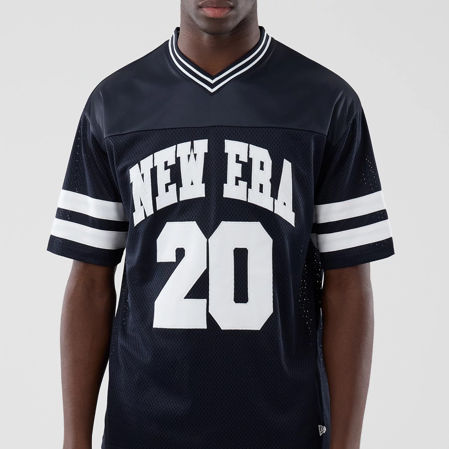 The model is wearing this New Era Mesh Oversized T-Shirt in navy. 3