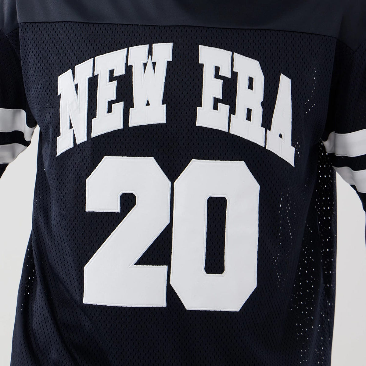 The model is wearing this New Era Mesh Oversized T-Shirt in navy. 4