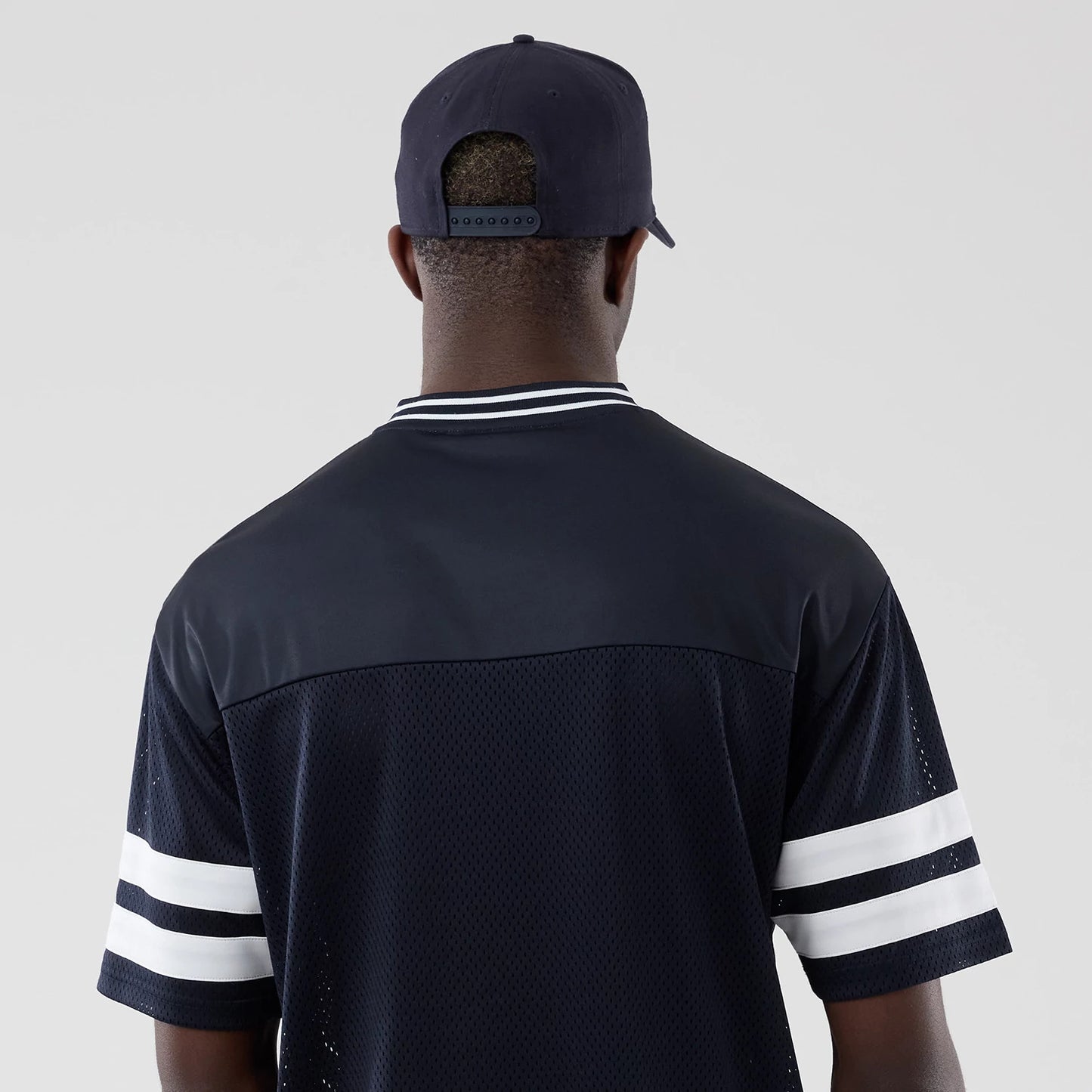 The model is wearing this New Era Mesh Oversized T-Shirt in navy. 7