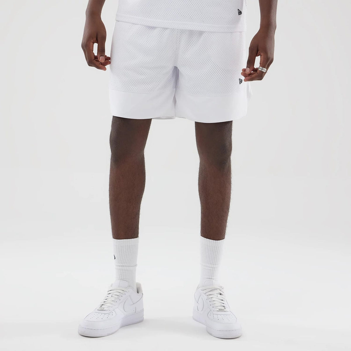 The model is wearing this New Era Mesh Oversized Shorts in white. 7