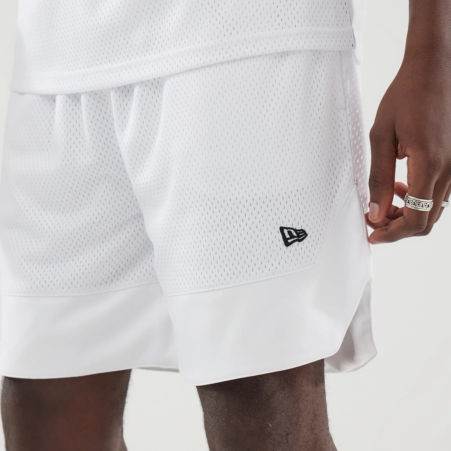 The model is wearing this New Era Mesh Oversized Shorts in white. 3