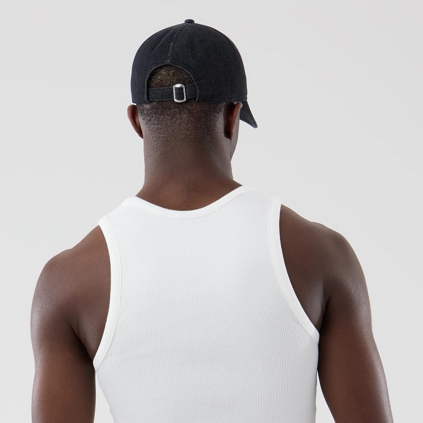 The model is wearing this New Era Rib Vest in white. 7