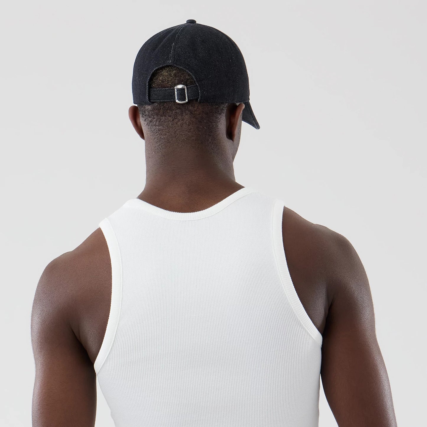 The model is wearing this New Era Rib Vest in white. 7
