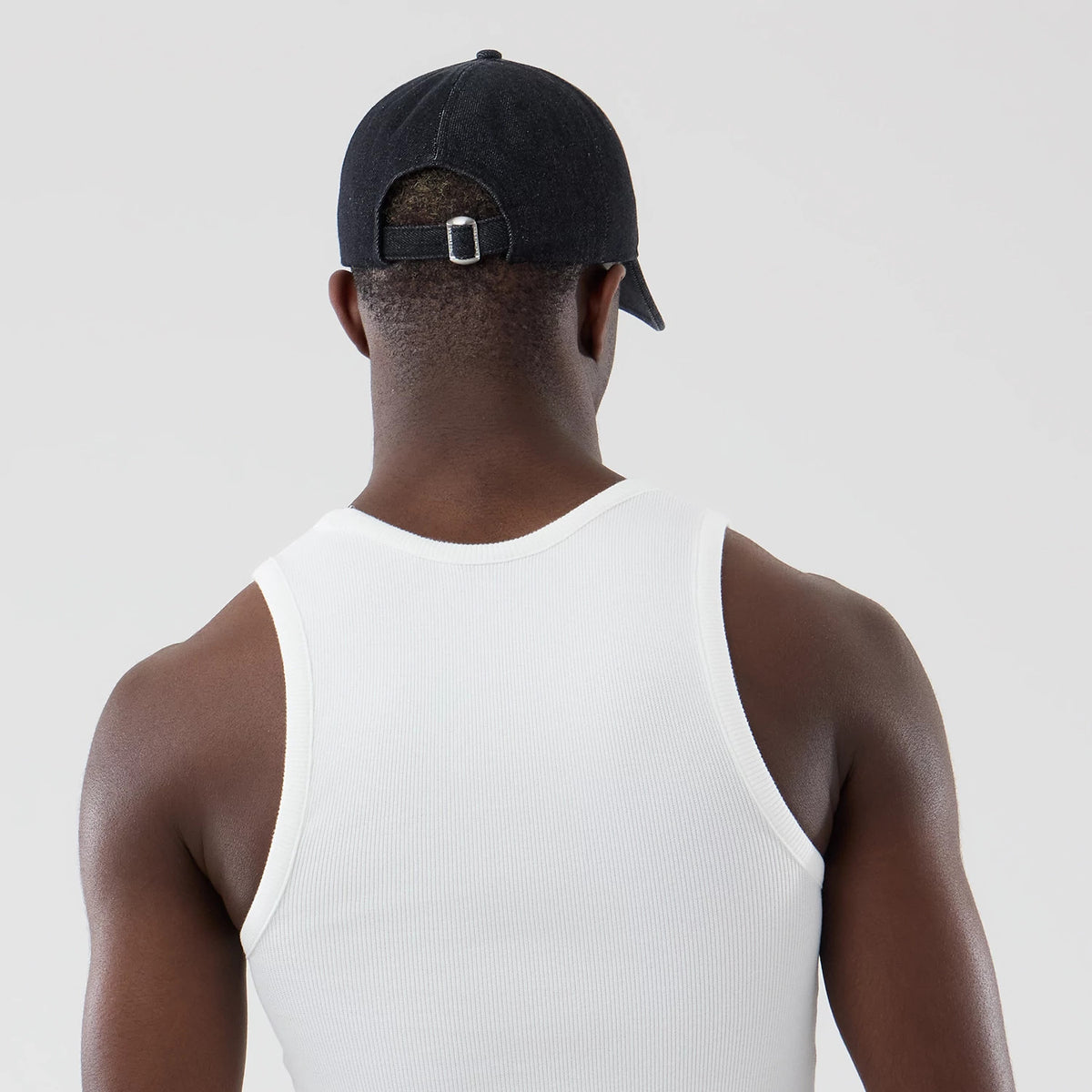 The model is wearing this New Era Rib Vest in white. 7