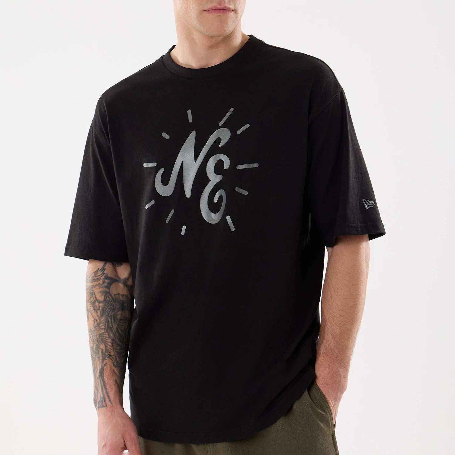 The model is wearing this New Era 59FIFTY Day Graphic T-Shirt in black. 3