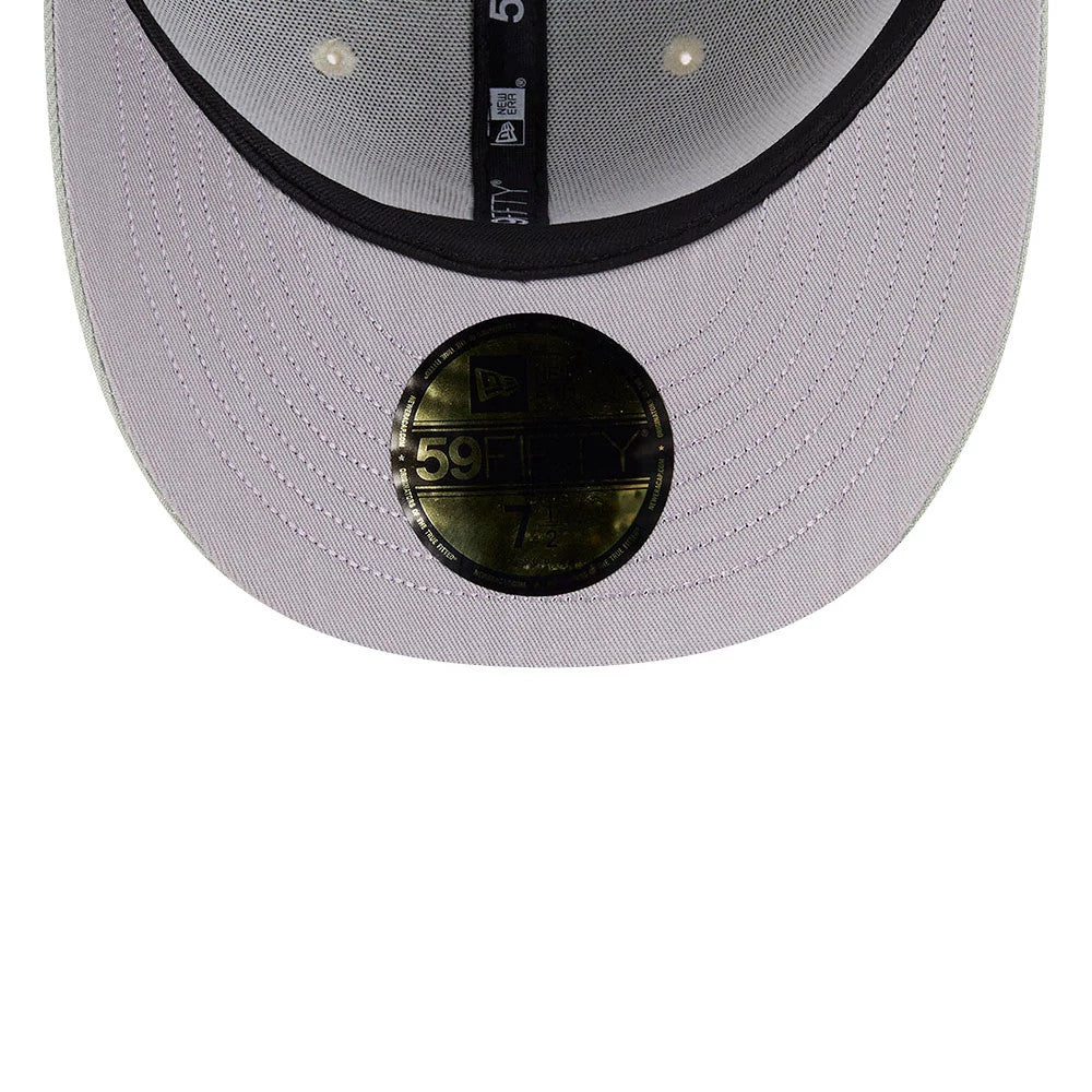 Atlanta Braves MLB Pastel Green New Era 59FIFTY Fitted Cap, inside view showing a black sweatband with New Era branding, grey undervisor with a gold 59FIFTY size sticker at the centre, and black taping with stitching lines.