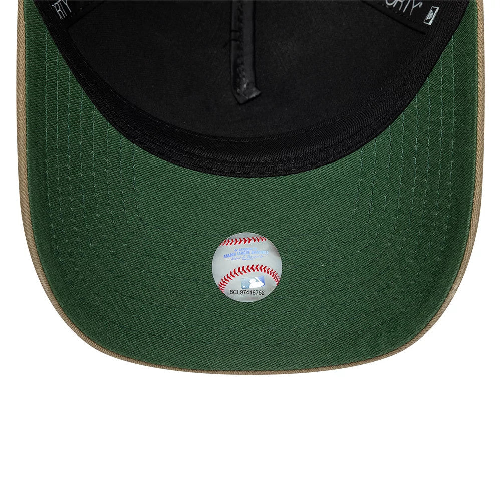 Chicago White Sox MLB Vibrant Festivities Beige New Era 9FORTY A-Frame Adjustable Cap, inside view showing the green undervisor with a white MLB baseball sticker in the centre, black branded taping, and a black sweatband.