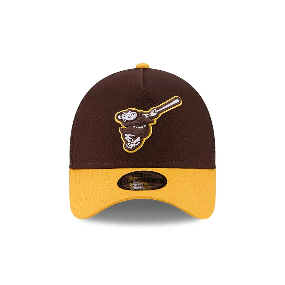 Padres MLB X Anchorman Whammy Dark Brown New Era 9FORTY A-Frame Trucker Adjustable Cap, front view featuring a raised white and brown embroidered Padres logo on the structured dark brown crown, with a contrasting yellow visor and 9FORTY size sticker.