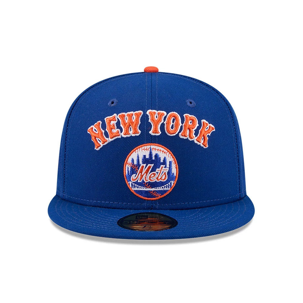 New York Mets MLB X Seinfeld Cooperstown Blue New Era 59FIFTY Fitted Cap, front view showing raised orange embroidered New York lettering and the Mets skyline logo on the structured blue crown, with a 59FIFTY size sticker on the blue flat visor.