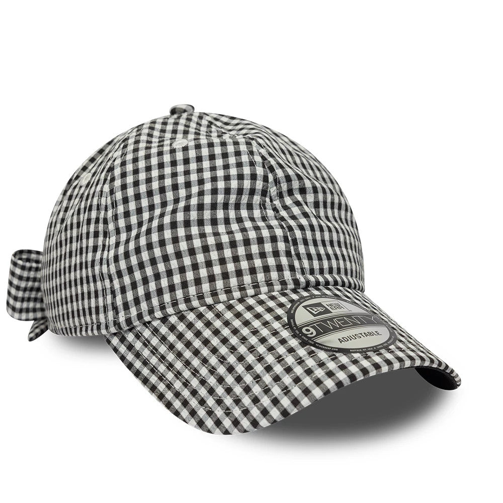 New Era Gingham Bowback Black 9TWENTY Adjustable Cap, three-quarter view showing a black and white gingham pattern across the entire cap, with a bow at the back and a 9TWENTY size sticker on the curved visor.
