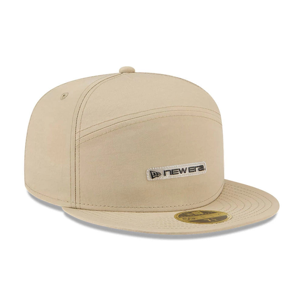 New Era 59FIFTY Day Cream Split Panel 59FIFTY Fitted Cap, three-quarter view showing a cream-coloured design with a New Era wordmark logo on the front panel, complemented by a flat cream visor with a gold 59FIFTY size sticker on top.