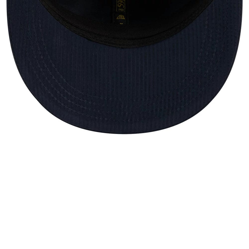 New Era 59FIFTY Day Seersucker Navy Retro Crown 59FIFTY Fitted Cap, inside view showing the black sweatband, the navy seersucker undervisor with its fine striped texture, and the gold New Era and size label sewn onto the inner crown.