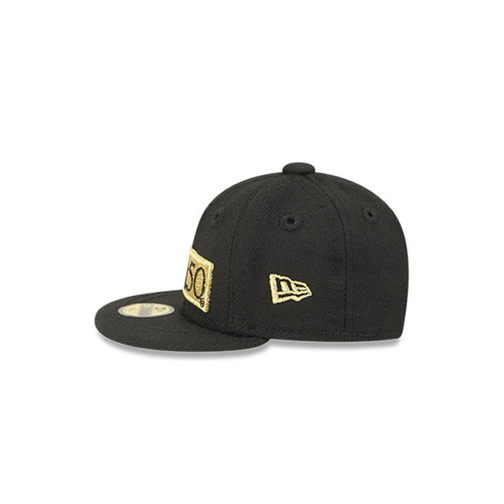 New Era 59FIFTY Day Black Mini 59FIFTY Fitted Cap, side view showing the gold embroidered New Era flag logo on the left side, a prominent gold 59FIFTY logo patch on the front panel, and a gold 59FIFTY size sticker on the flat visor.