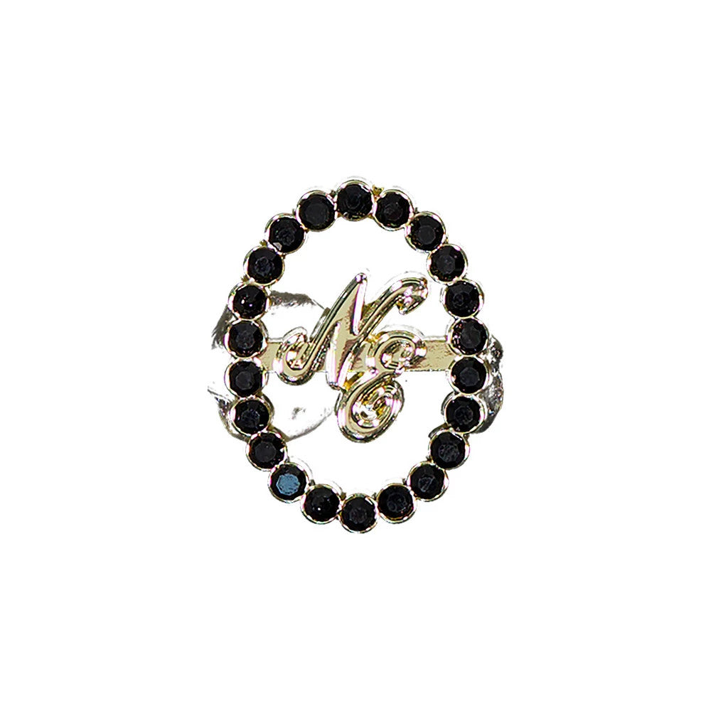New Era 59FIFTY Day Diamond Catch Closure Black Pin Badge, front view displaying a circular design with black gemstones lining the edge, featuring an intricate gold NE script logo centred within the oval, and a catch closure on the back.