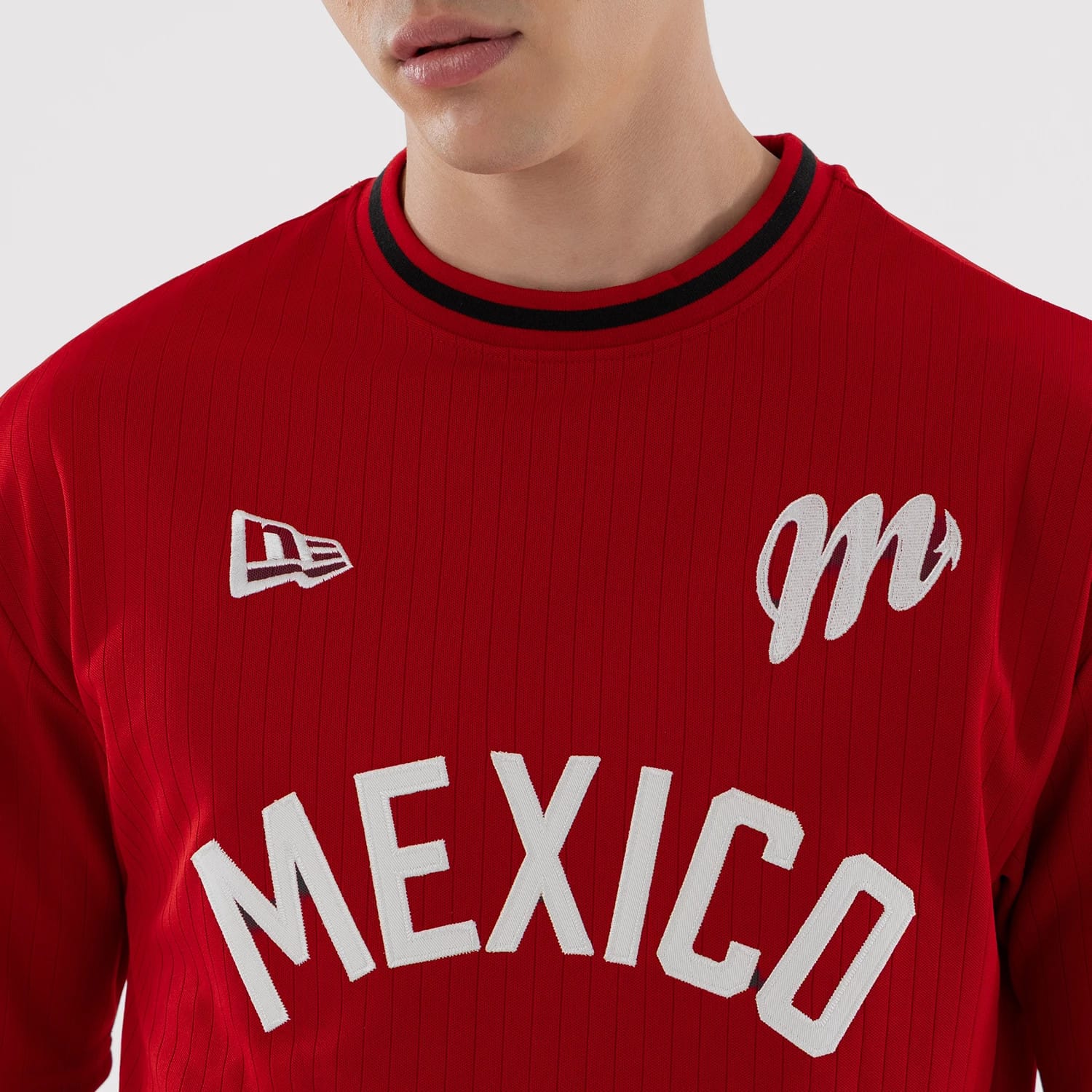 The model is wearing this LMB Mexico Diablos Oversized T-Shirt in red. 4